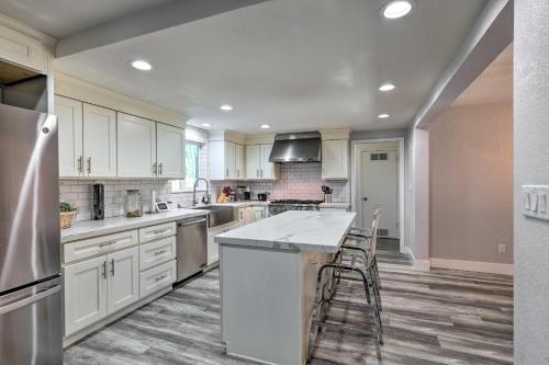 a kitchen with white cabinets and a counter top at Modesto Home with Deck - 2 Mi to Vintage Faire Mall in Modesto