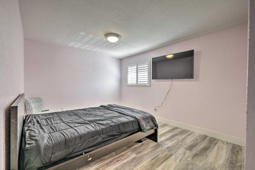 a bedroom with a bed and a flat screen tv at Modesto Home with Deck - 2 Mi to Vintage Faire Mall in Modesto