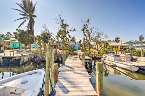 a dock with boats docked next to a house at Little Gasparilla Home Walk to Beaches! in Placida