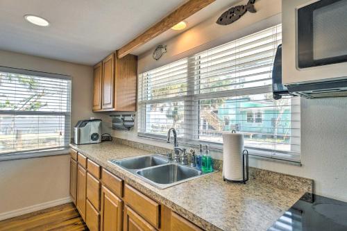 a kitchen with a sink and two windows at Little Gasparilla Home Walk to Beaches! in Placida