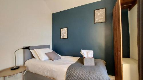 Large 4 bedroom / 7 guests house في دونكاستير: غرفة نوم بسرير مع جدار ازرق