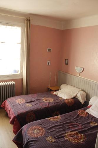 a bedroom with two beds and a window at Le Logis Catalan - Gîte de groupe et familial in Font-Romeu