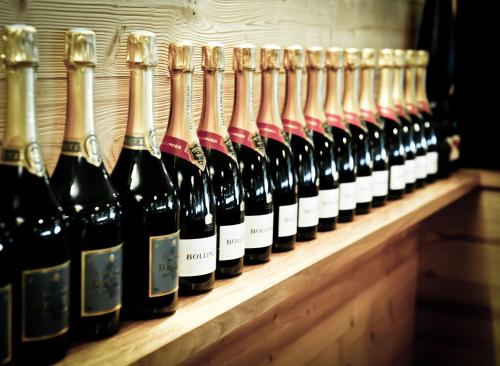a row of wine bottles lined up on a shelf at Chalet Hotel Régina in Les Gets