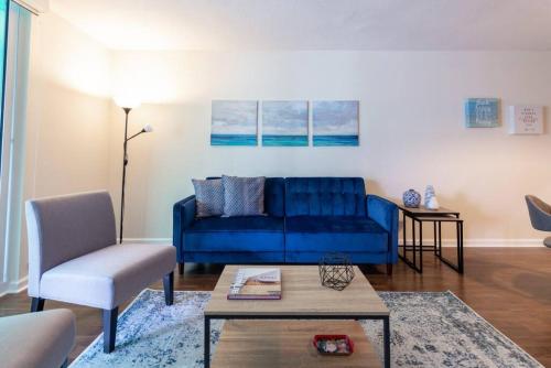 a living room with a blue couch and a table at Absolutely Beautiful 1 BR Paradise with a Huge balcony in Miami