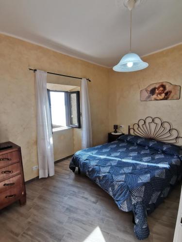 a bedroom with a bed and a window at Il Torrione in Poggio Bustone
