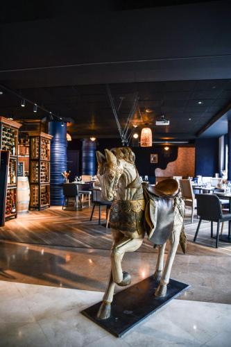 a statue of a man riding a horse in a restaurant at Hotel Mercure Château de Fontainebleau in Fontainebleau