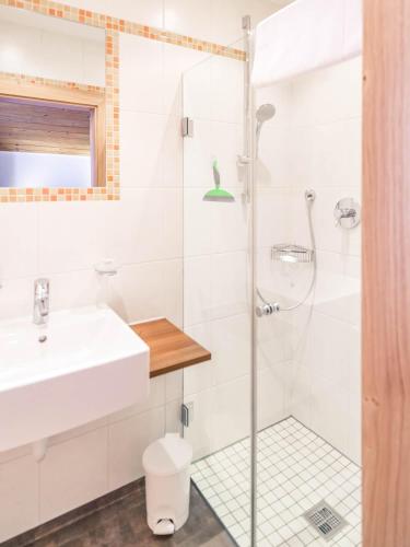 a bathroom with a shower and a sink at Haus Kristall in Tannheim