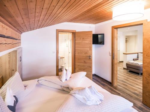 a bedroom with two beds and a television in a room at Haus Kristall in Tannheim