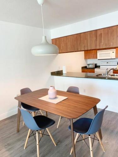 a kitchen with a wooden table and chairs at Super Cool 1BR Apartment in Brickell with Parking in Miami
