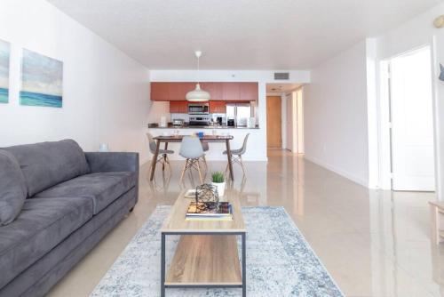 a living room with a couch and a table at Sunshine Ocean and City Views 1 BR Paradise with Parking in Miami