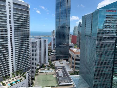 a city with a tennis court in the middle of buildings at Sunshine Ocean and City Views 1 BR Paradise with Parking in Miami