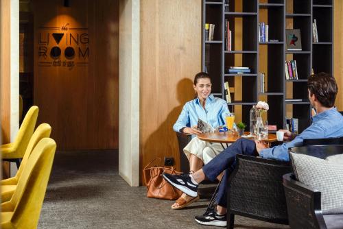 two people sitting at a table in a room at Anatolia Hotel in Thessaloniki