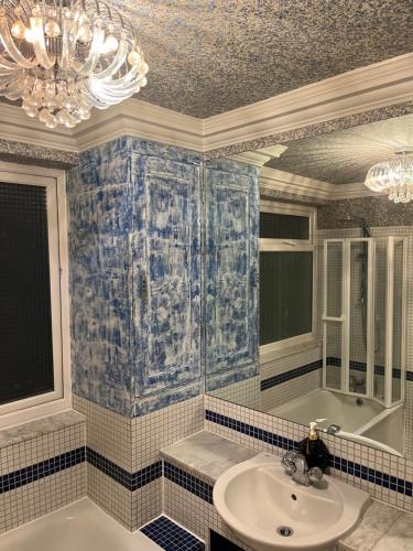 uma casa de banho com um lavatório e um lustre em TJ Homes - Double room with Single Bed - 3 Min to Tube station - London em Ruislip