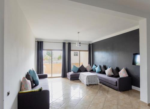 a living room with two couches and a tv at lafamilia in Marrakech