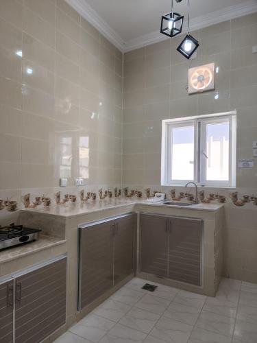 a large bathroom with a sink and a window at Blue Dome Chalet شاليه القبة الزرقاء in Al Raka