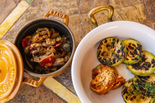 a bowl of food next to a bowl of mushrooms at Hotel Signum in Malfa