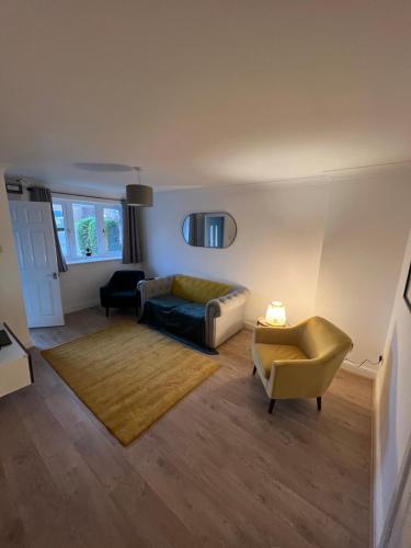 a living room with a couch and a chair at Chase View - Dog Friendly - Close to Cannock Chase - Great Motorway Links - Perfect for contractors and leisure in Hednesford