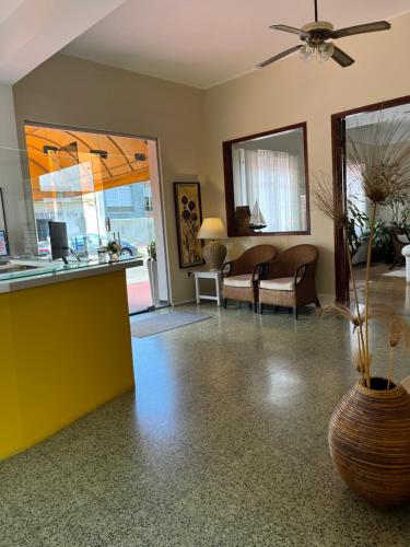 a living room with a vase on the floor at Hotel Tamariz in Piriápolis