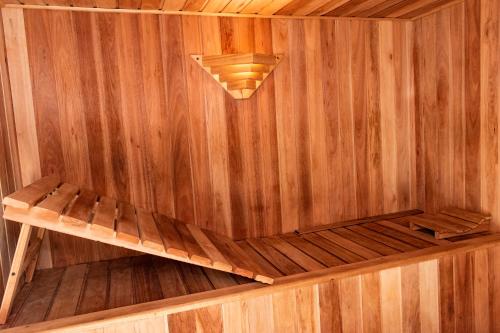 a sauna with a bench in a wooden wall at Hotel Traful in Mar del Plata