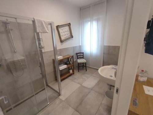 a bathroom with a shower and a sink at fuORIOrbita in Orio al Serio