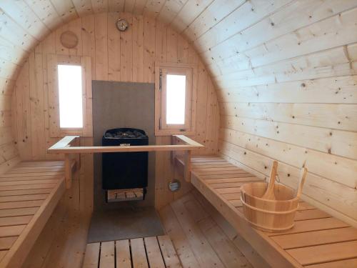 an inside view of a wooden cabin with a stove at Gasthof Klug zum Ehrensepp in Modriach