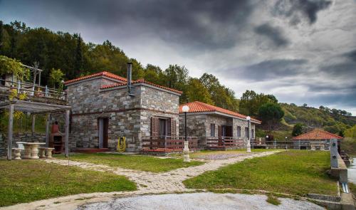 a small stone house in the middle of a field at 916 Mountain Resort in Xanthi