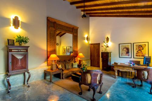 a living room with a table and a mirror at Aditya Resort in Hikkaduwa
