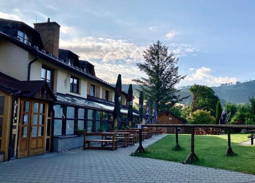 a building with a bunch of benches in front of it at Hotel STARÝ MLÝN in Jeseník