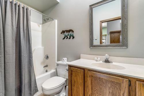 a bathroom with a sink and a toilet and a mirror at Skyleaf 703 in Sugar Mountain