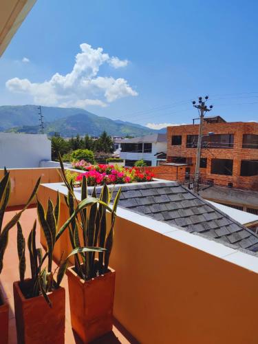 a balcony with plants on the roof of a building at Hotel Sumaq Kay in Cumbayá