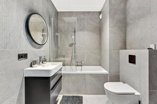 a bathroom with a toilet and a sink and a tub at Dom & House - Apartments Old Town Scala in Gdańsk