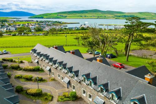 an old building with a view of a town and a body of water at Dingle Courtyard Cottages - 3 Bed NO 12 in Dingle