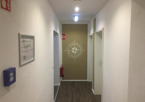 a hallway with a stairwell with a clock on the wall at Hotel Sonnenschein - Spielerei im Sonnenschein in Dahme