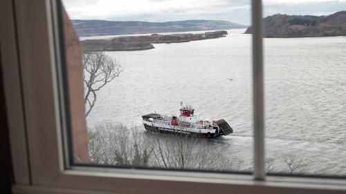 a boat floating in a large body of water at Western Isles Hotel in Tobermory