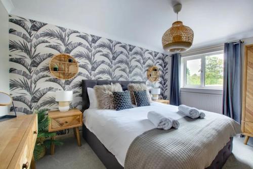 1 dormitorio con 1 cama grande y toallas. en Belle Vue Cottage, en Downham Market