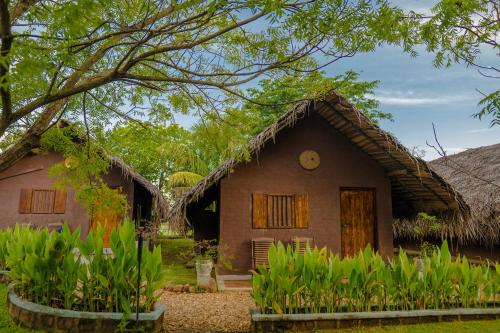 a small house with a thatched roof at Gaga Bees Yala in Tissamaharama
