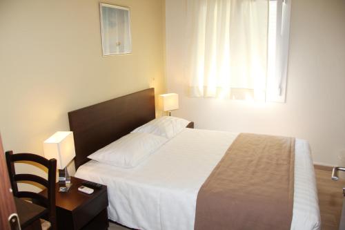 Un ou plusieurs lits dans un hébergement de l'établissement Rea Hotel