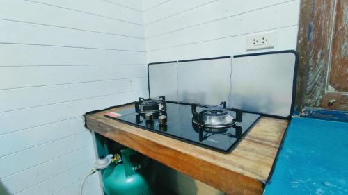 a counter with two pots and pans on a stove at Baan Laanta@Lanta in Ko Lanta