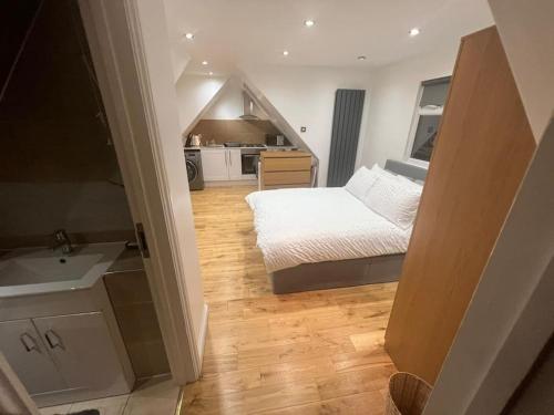ein kleines Schlafzimmer mit einem Bett und einer Küche in der Unterkunft Hampden Rd N8,Studio Flat in London