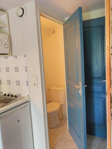 bagno con servizi igienici e porta blu di Maison de vacances 5P dans résidence a Le Barcarès