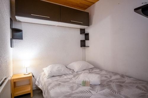 a small bedroom with a bed with two pillows at Comfortable apartment with beautiful view - Welkeys in LʼHuez