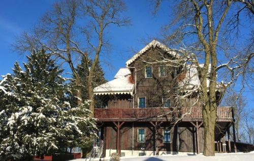 a large brick house with snow on the ground at Dambachhaus Thale in Thale