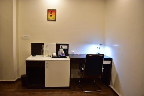 a desk with a chair in a room at HOTEL MONTANA VYOO in Namchi