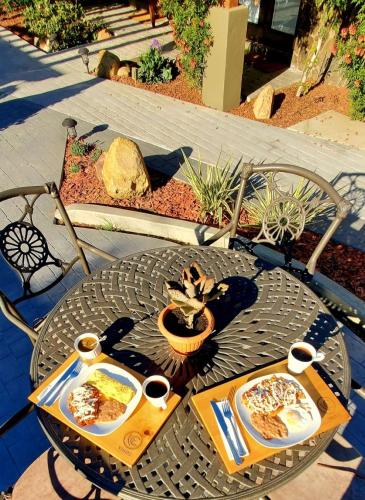 a table with two plates of food and two cups of coffee at Casa Emiliana in Valle de Guadalupe