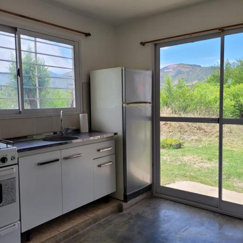 a kitchen with a refrigerator and a sliding glass door at Bella Vista in Valle Hermoso