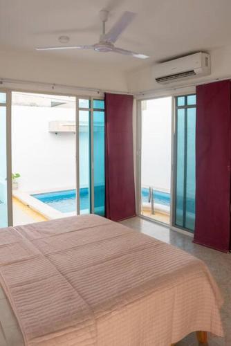 a bedroom with a bed with a view of the ocean at Casa Medina in Chetumal