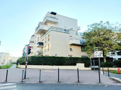 een groot wit gebouw in een stadsstraat bij Cosy Home 1, Cergy Le Haut, 6 personnes, 3 min gare, 30 min Paris, parking privé in Cergy