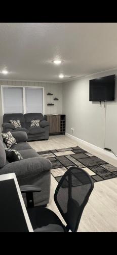 a living room with a couch and a flat screen tv at The Jewel of Jacksonville in Jacksonville