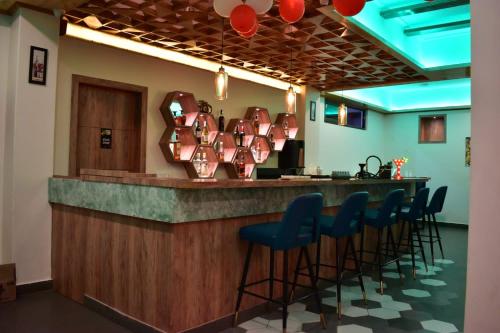 a bar with blue bar stools at a restaurant at HOTEL MONTANA VYOO in Namchi