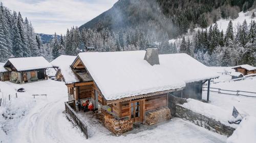 a log cabin with snow on the roof at Chalet Le R'Posiao in Morzine